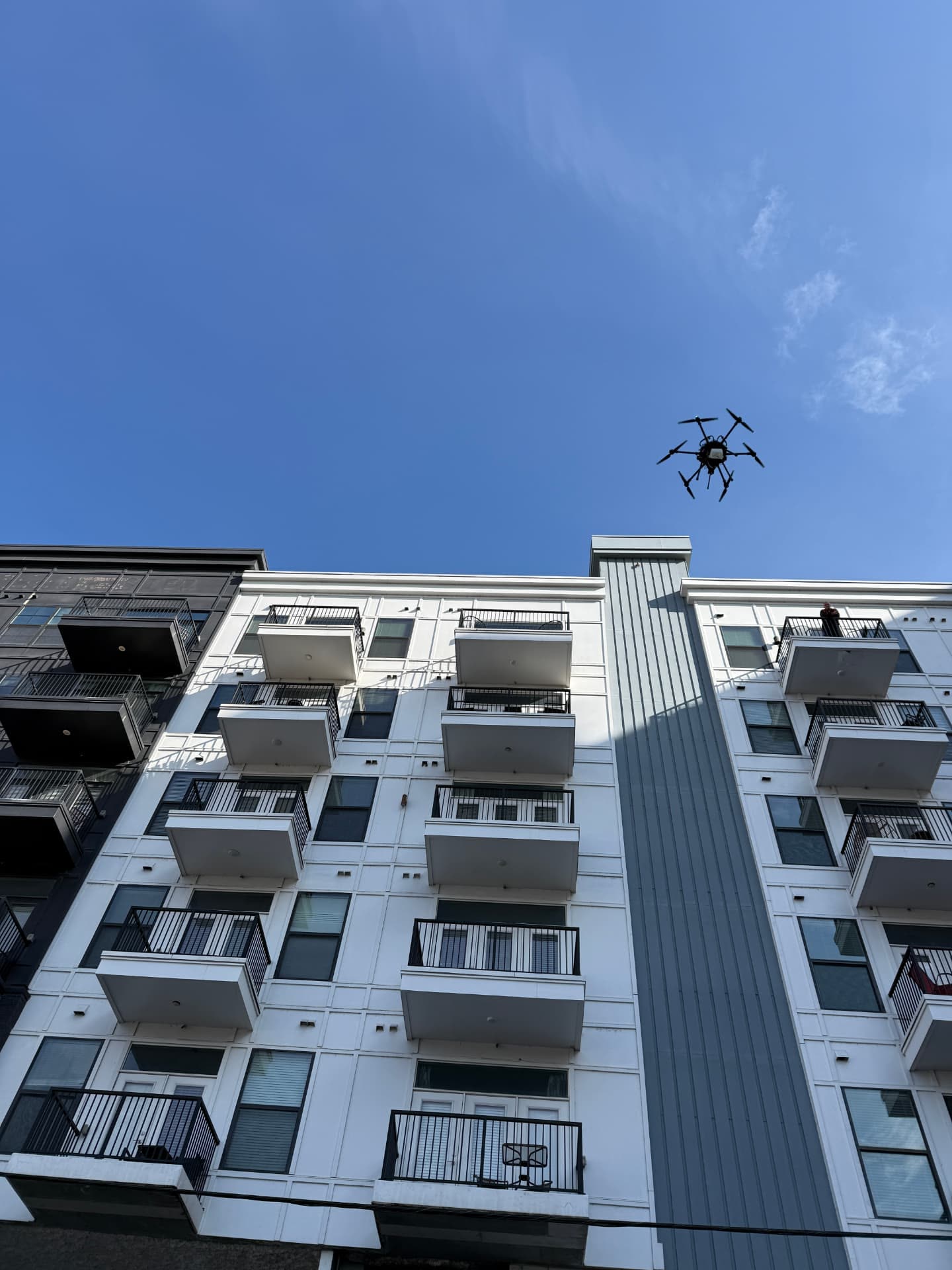 Drone in flight above a multifamily residential building