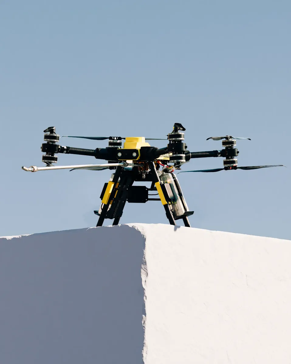 Apellix cleaning drone resting on the corner of a white commercial building