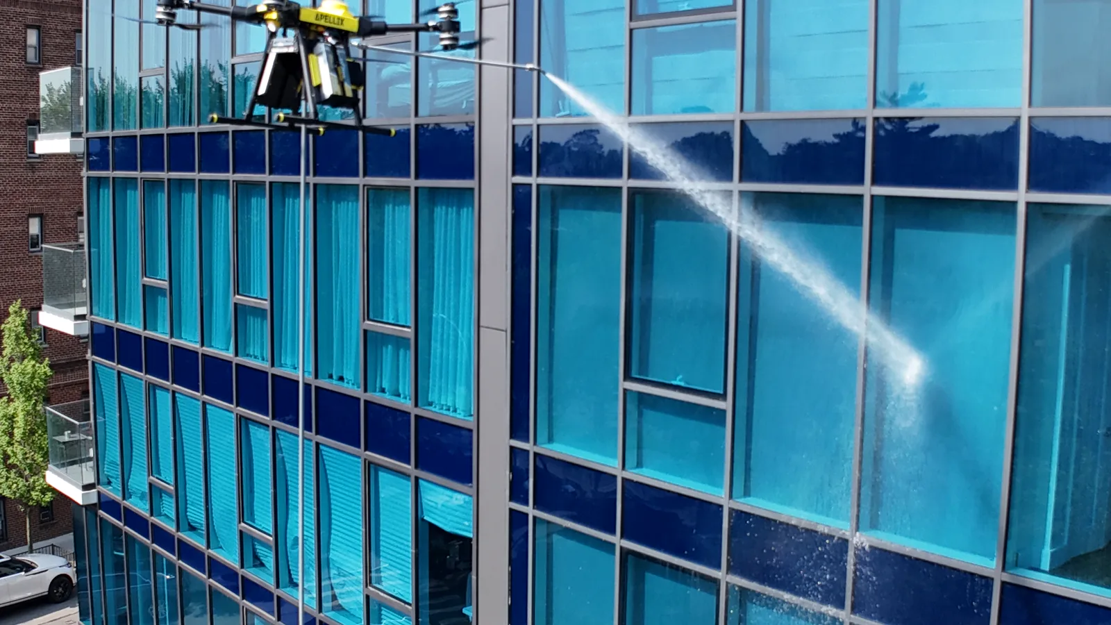 Apellix B2 cleaning windows on a commercial building